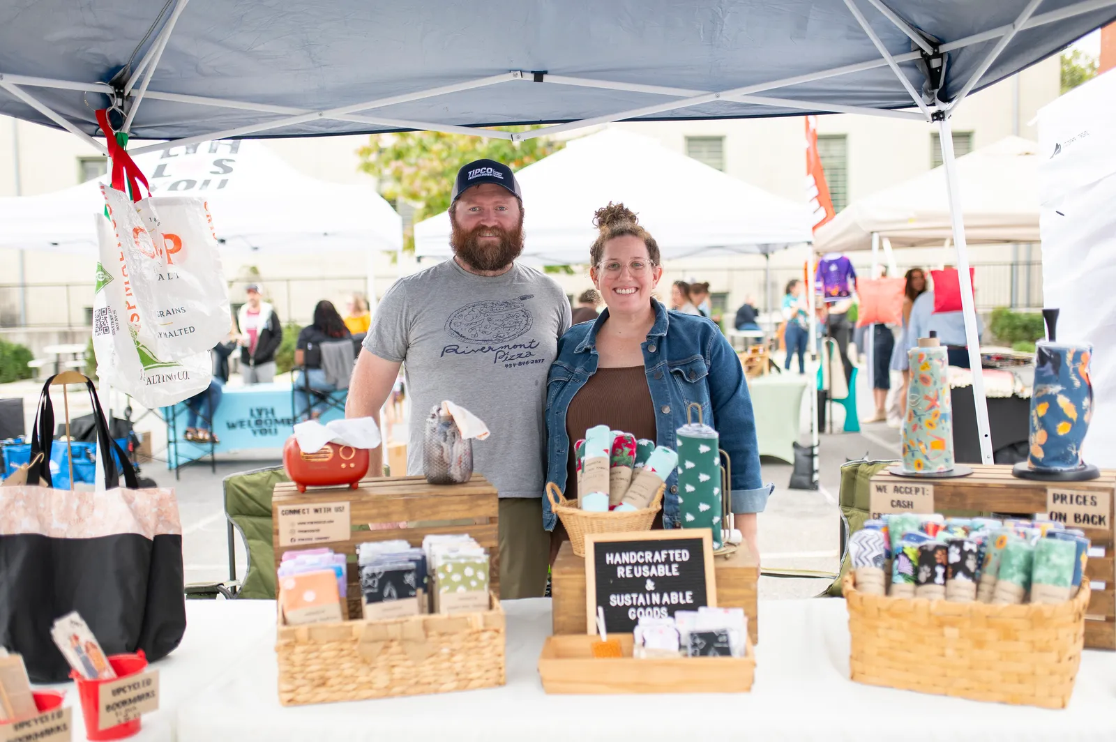 A small business showing handcrafted goods under a tent at Books & Brews