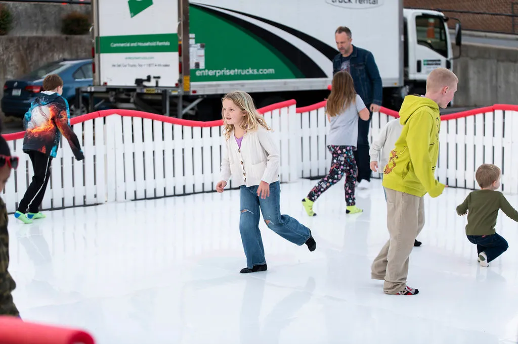 Families skating on Commerce Street during the Bright Nights Block Party