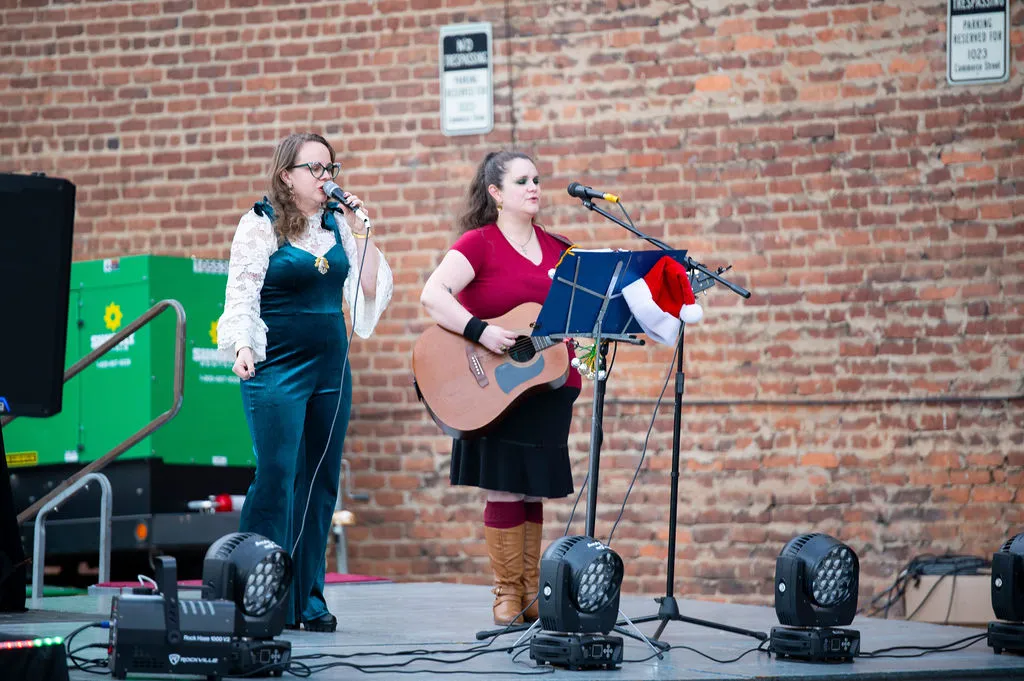A duo performing live on the Bright Nights Block Party stage