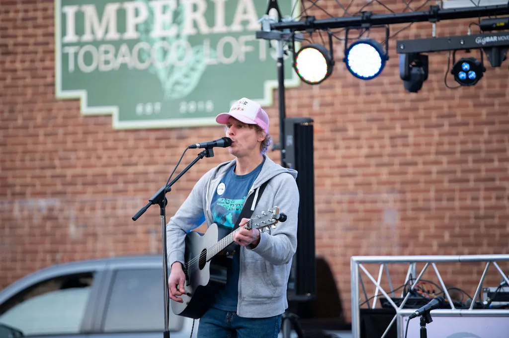 A musician playing outside the Imperial Tobacco Lofts at the Bright Nights Block Party