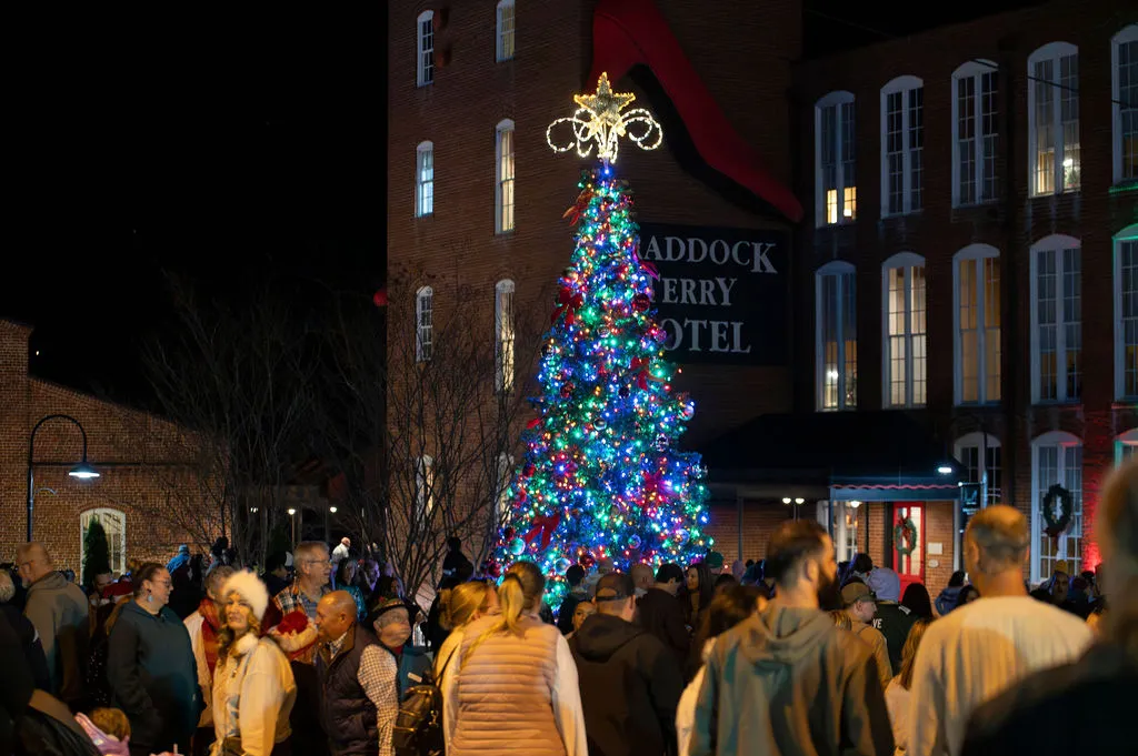 The crowd gathered around the lit Christmas tree outside the Craddock Terry Hotel