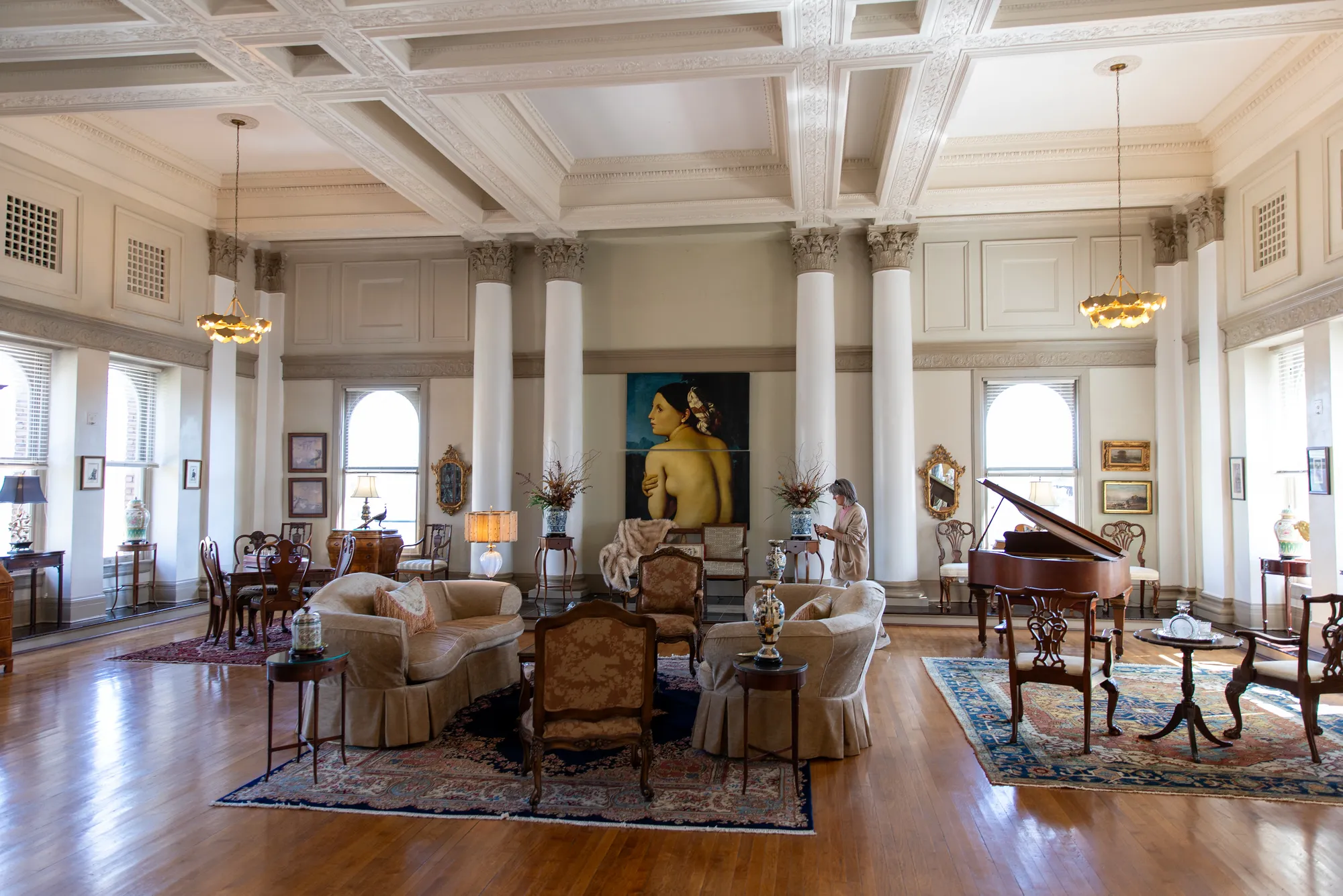A grand, light-filled downtown Lynchburg loft with soaring columns, coffered ceilings, and antique furnishings