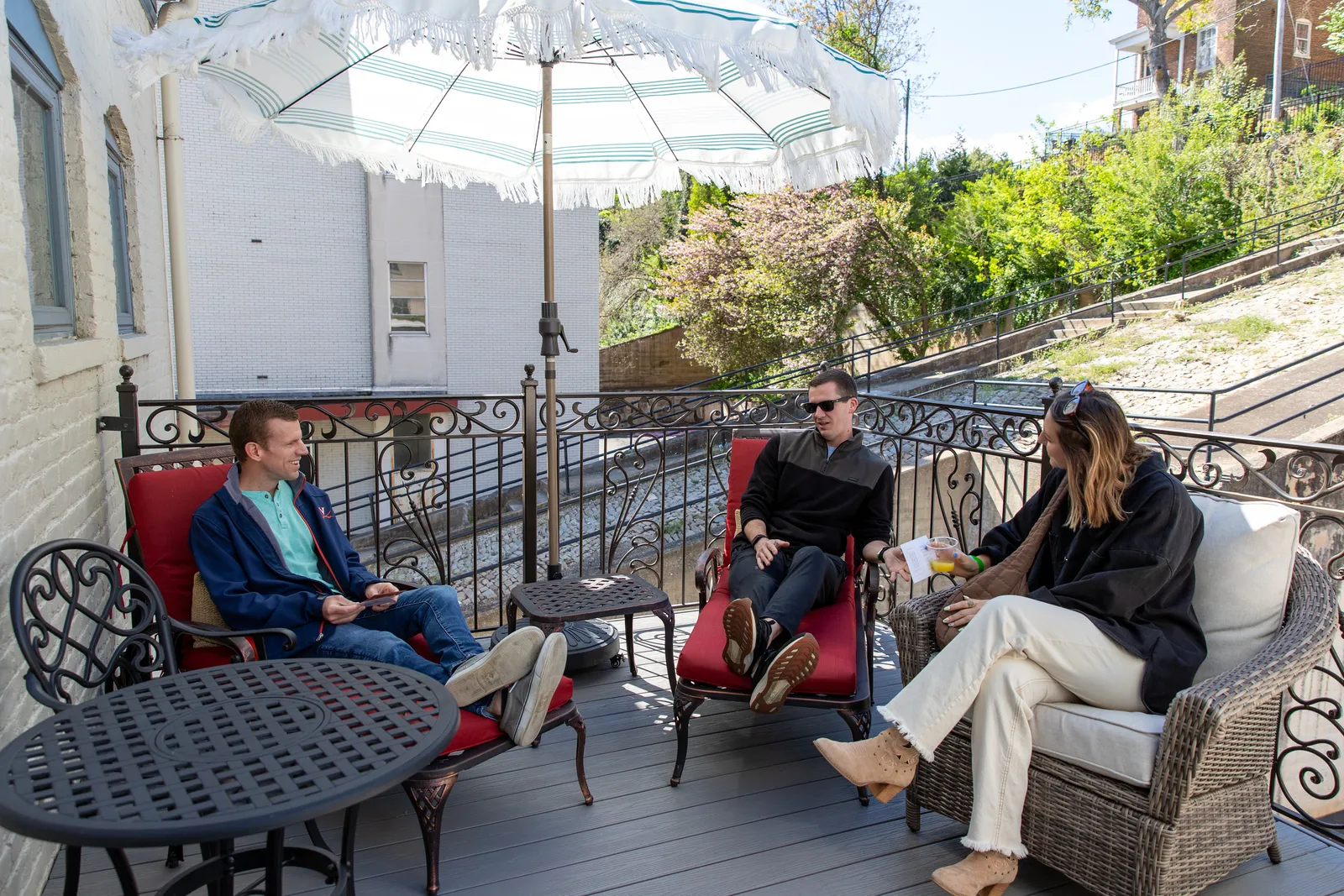 Guests relaxing on a downtown loft’s private deck overlooking a cobblestone street