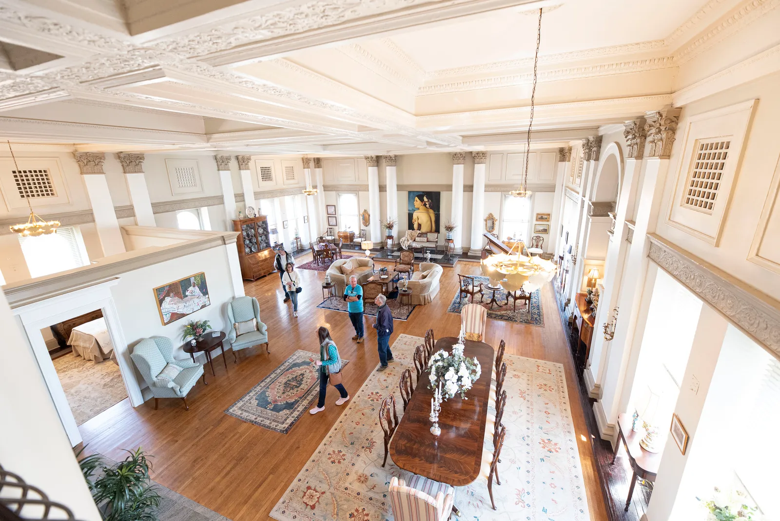Loft Life tour-goers exploring a grand restored living space with soaring ceilings